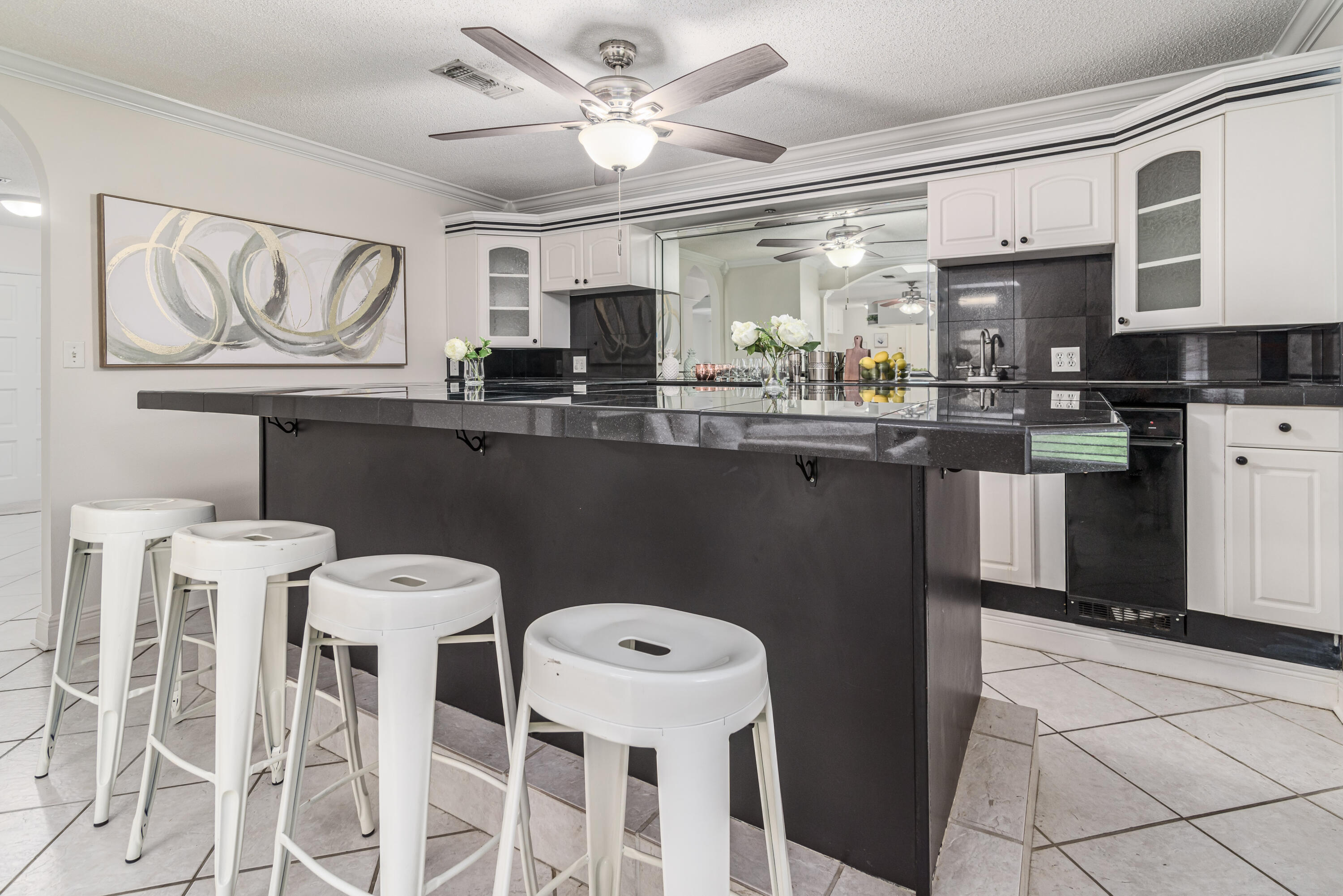 207 Country Club Road Shalimar, FL 32579 - Photo 32 of 60 a kitchen with stainless steel appliances a table chairs and a refrigerator