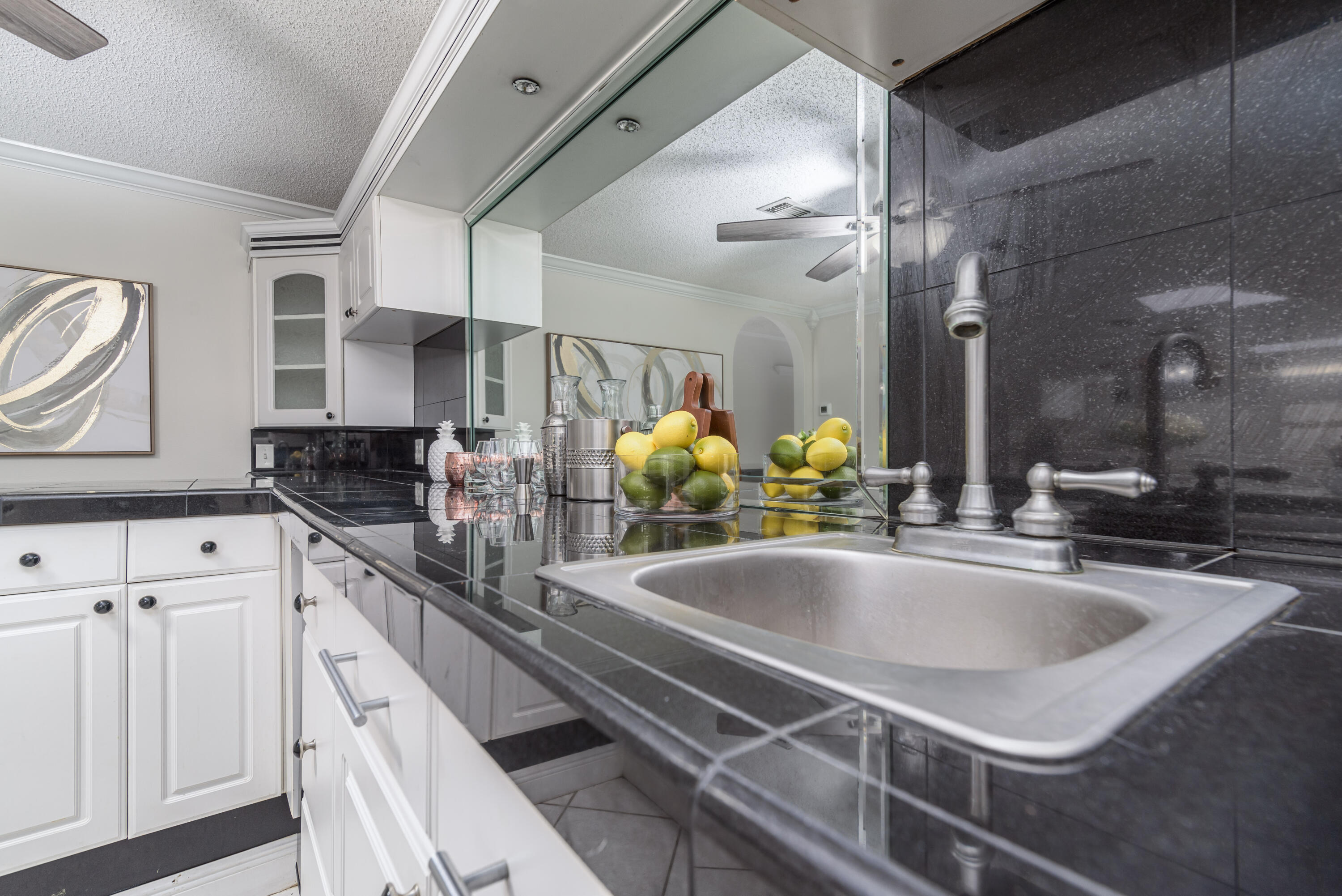 207 Country Club Road Shalimar, FL 32579 - Photo 34 of 60 a kitchen with granite countertop a sink and white cabinets