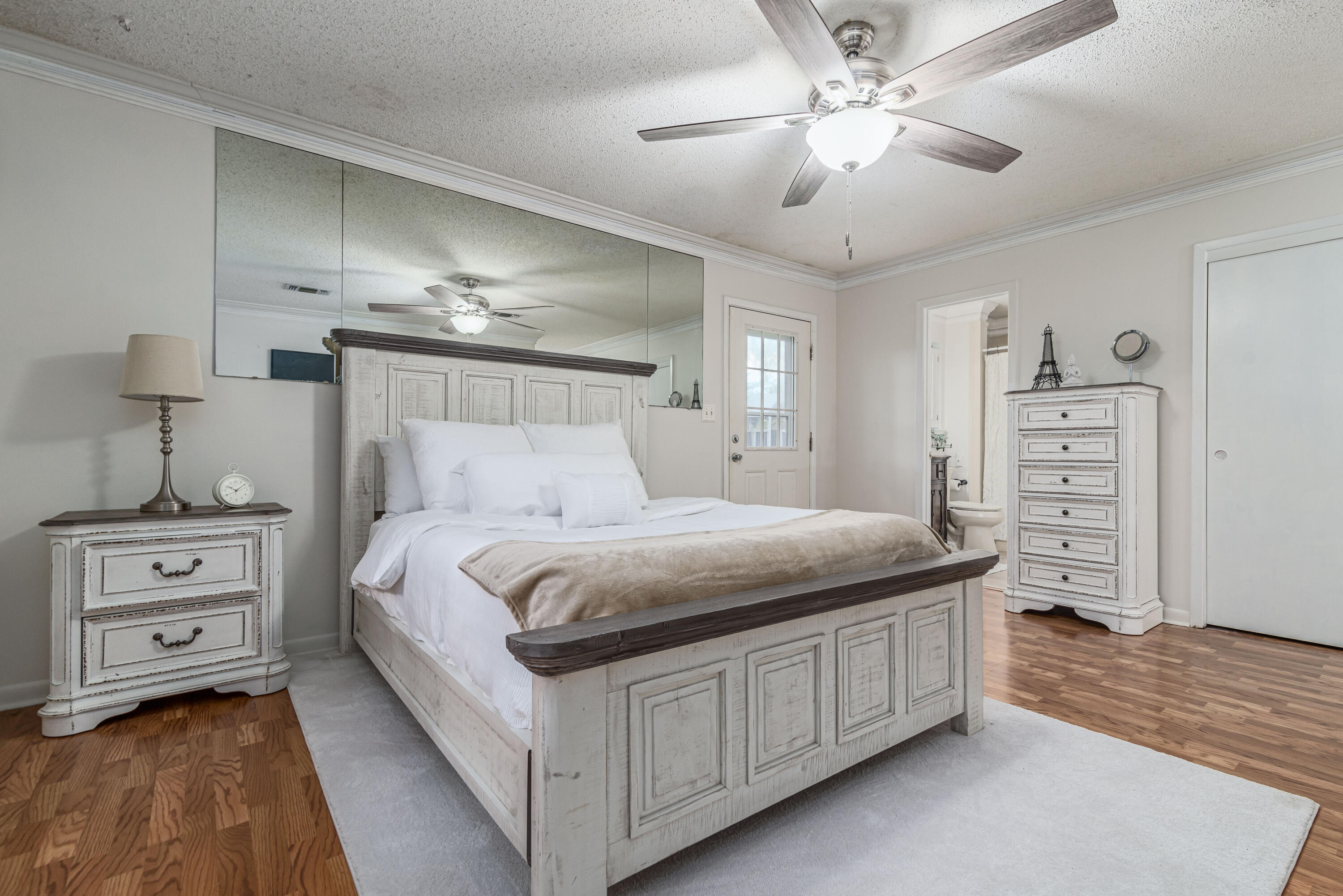 207 Country Club Road Shalimar, FL 32579 - Photo 38 of 60 a bedroom with a bed and a chandelier