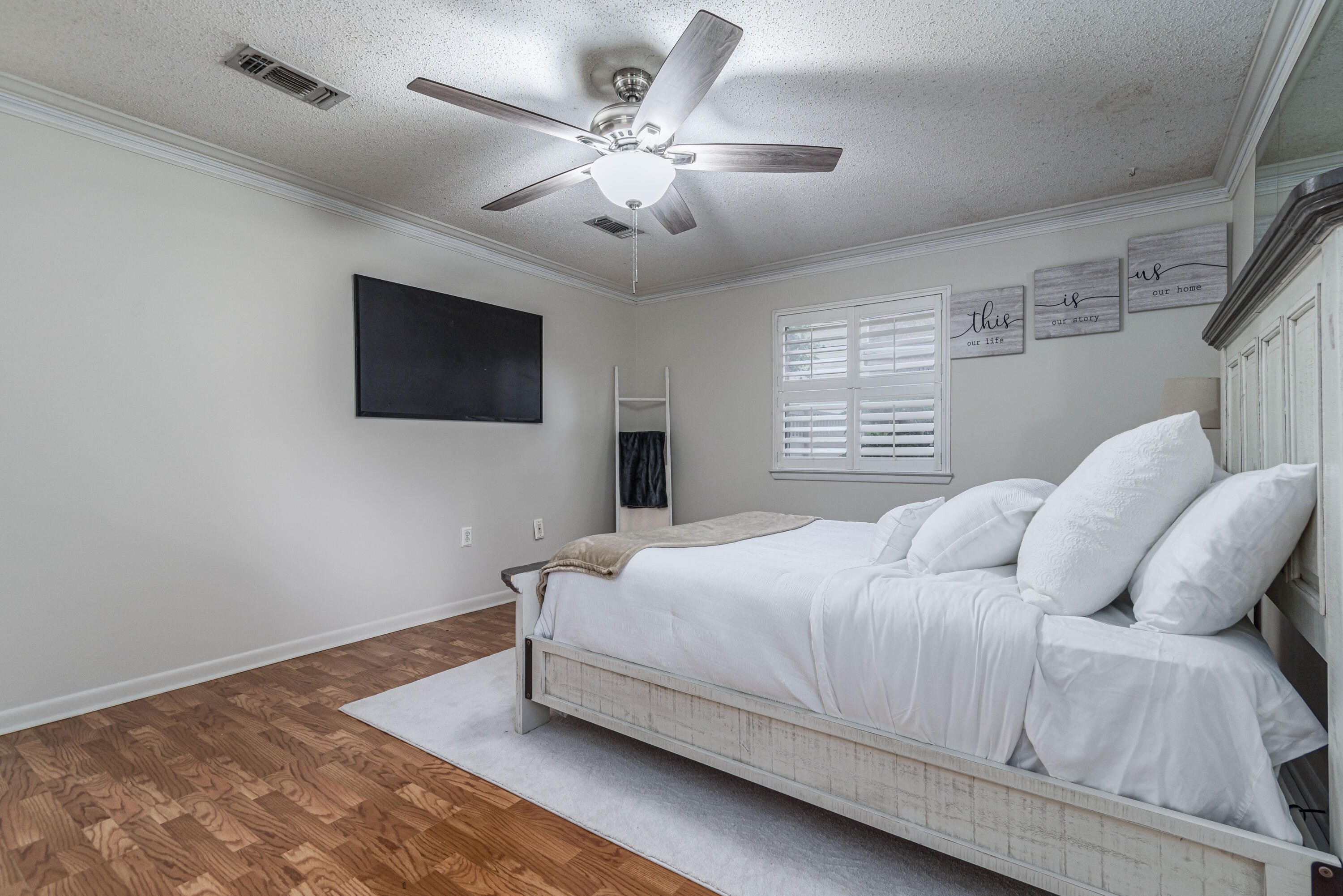 207 Country Club Road Shalimar, FL 32579 - Photo 40 of 60 a bedroom with a large bed and a flat screen tv