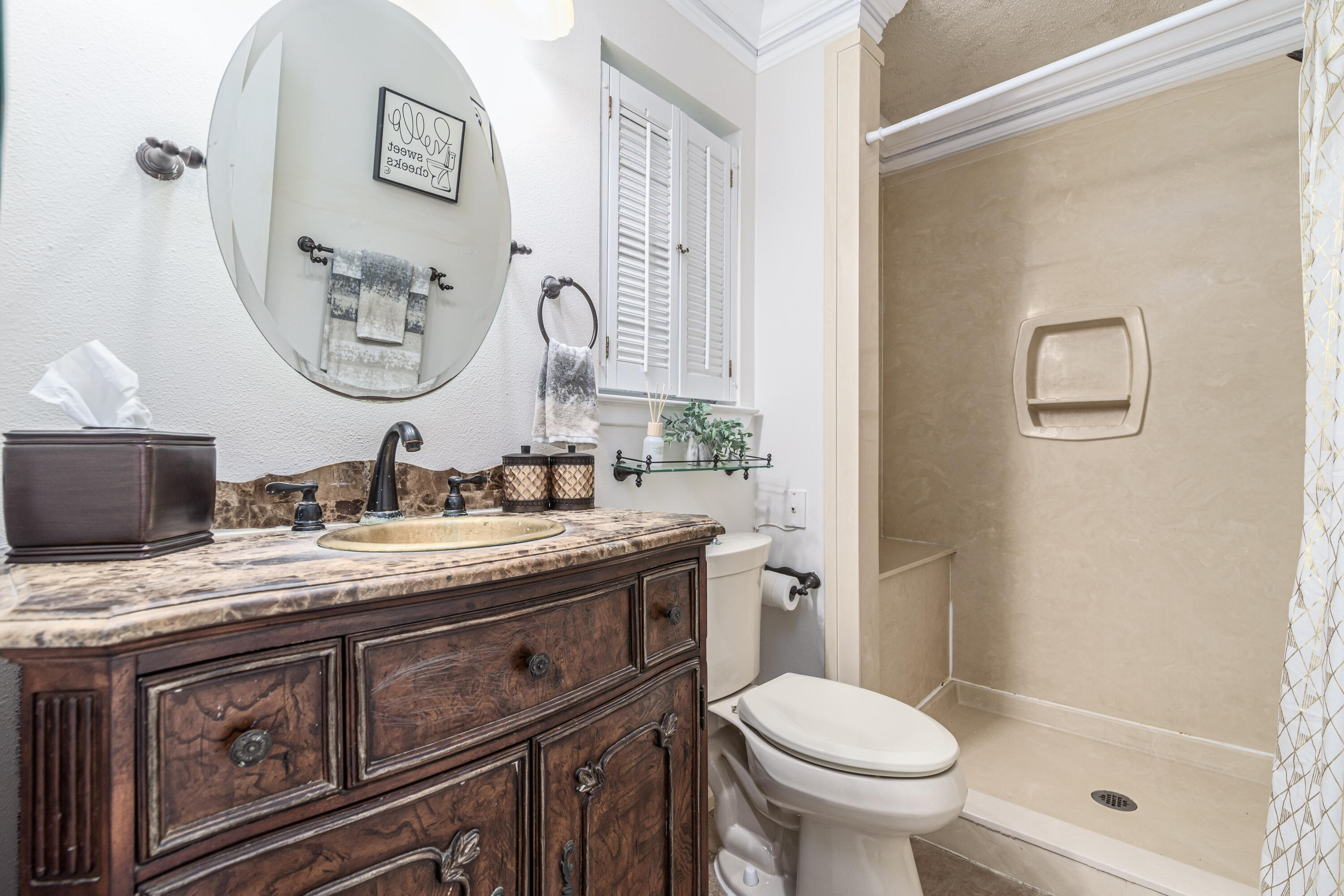 207 Country Club Road Shalimar, FL 32579 - Photo 41 of 60 a bathroom with a granite countertop toilet sink and mirror