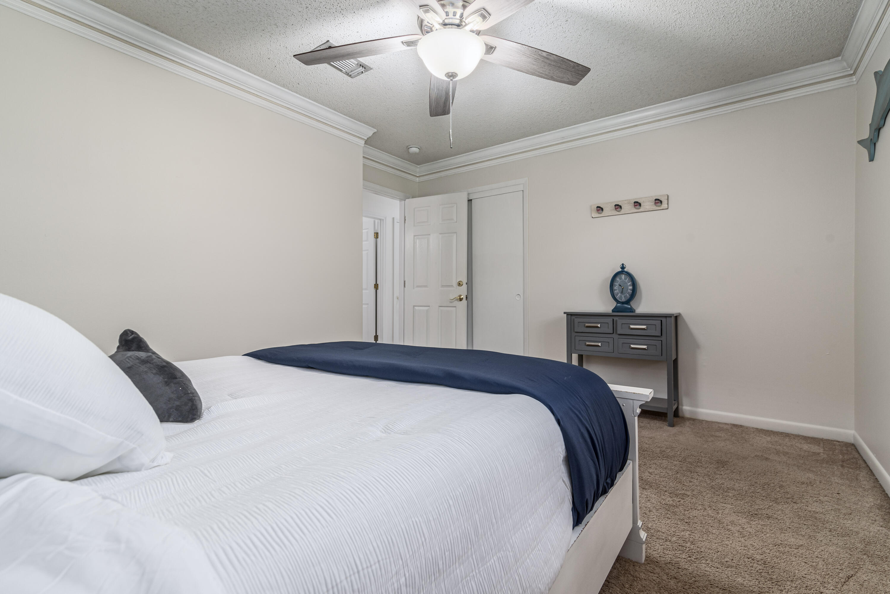 207 Country Club Road Shalimar, FL 32579 - Photo 45 of 60 a bedroom with a bed and a chandelier