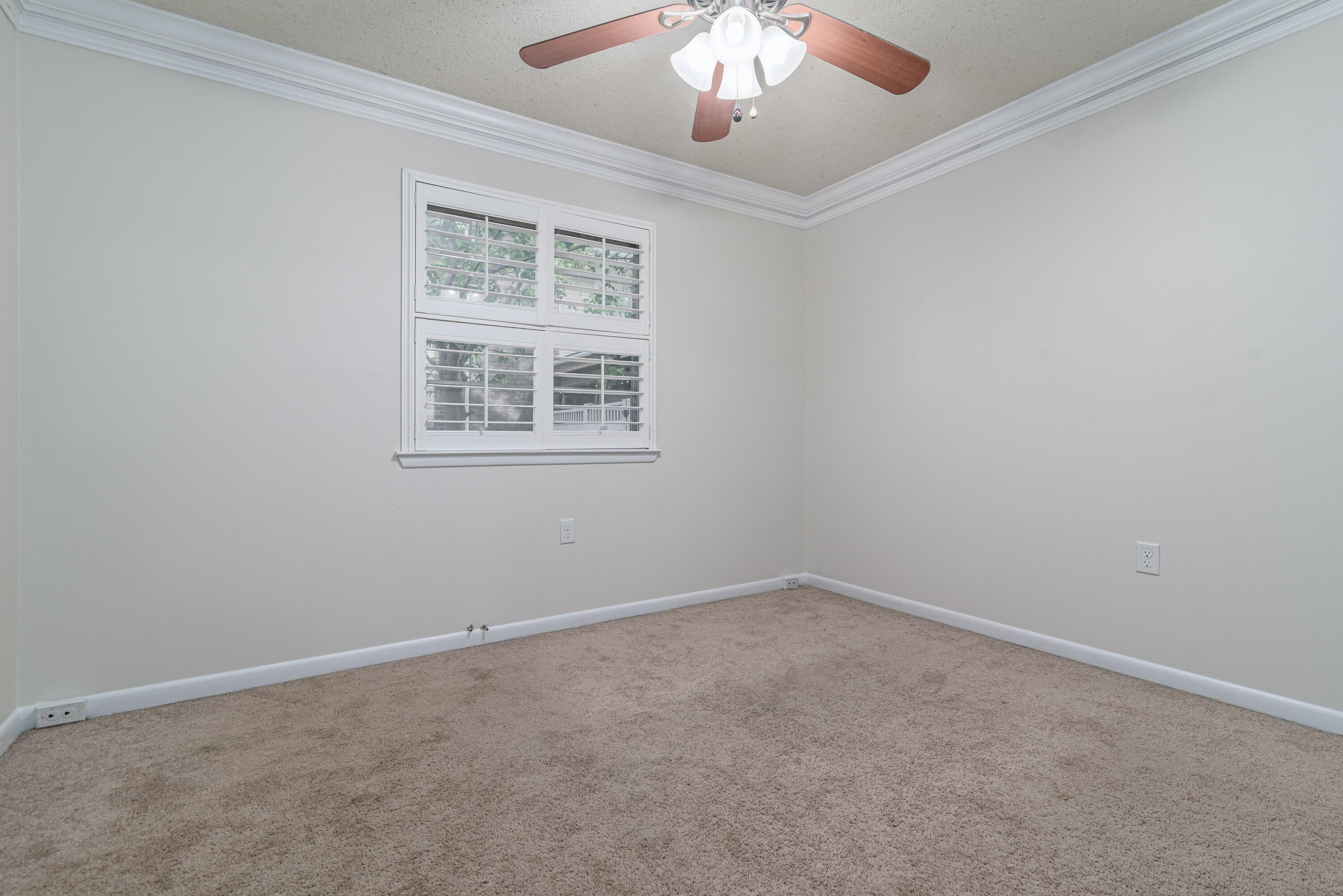 207 Country Club Road Shalimar, FL 32579 - Photo 47 of 60 an empty room with a chandelier fan
