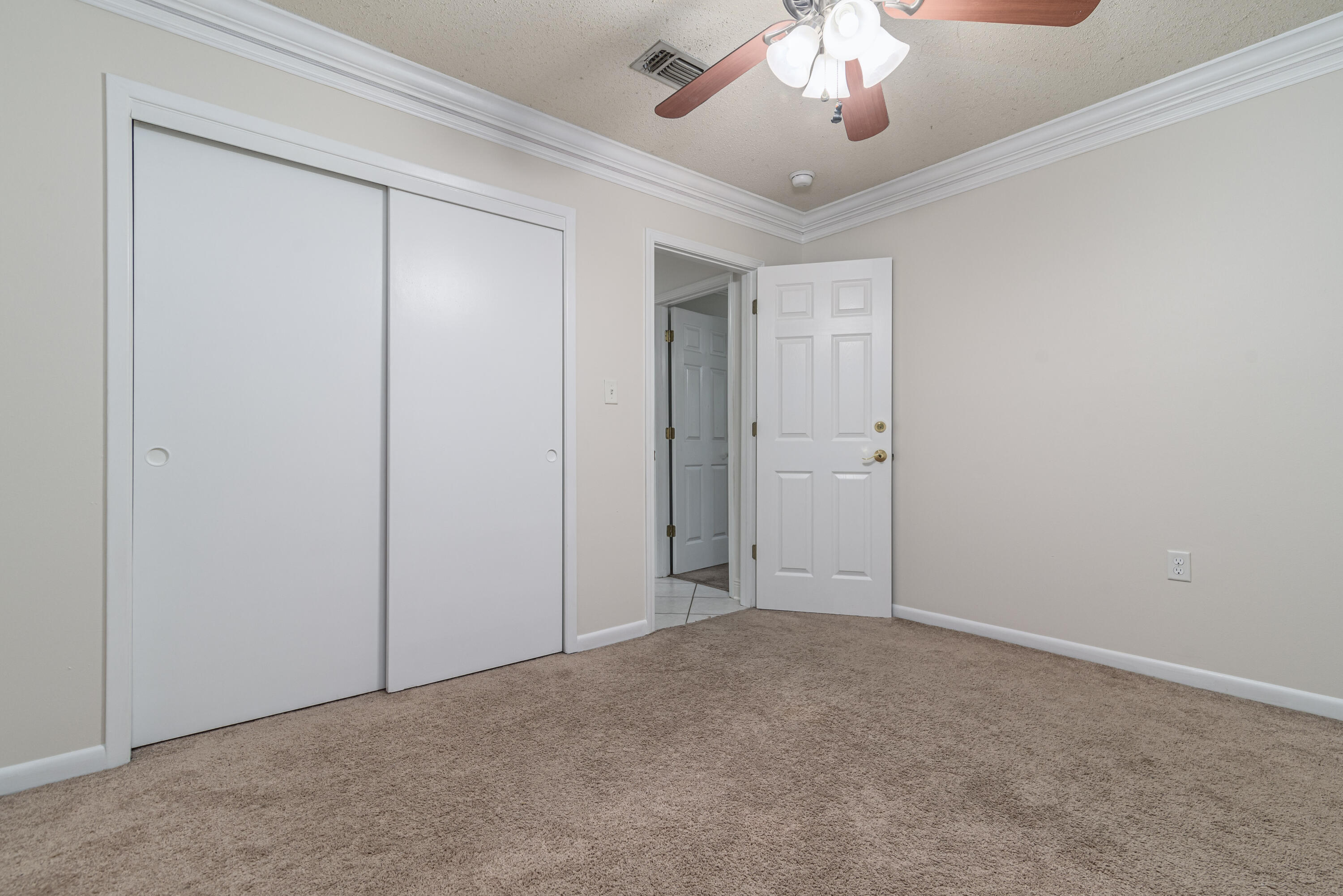 207 Country Club Road Shalimar, FL 32579 - Photo 48 of 60 a view of an empty room with a chandelier fan