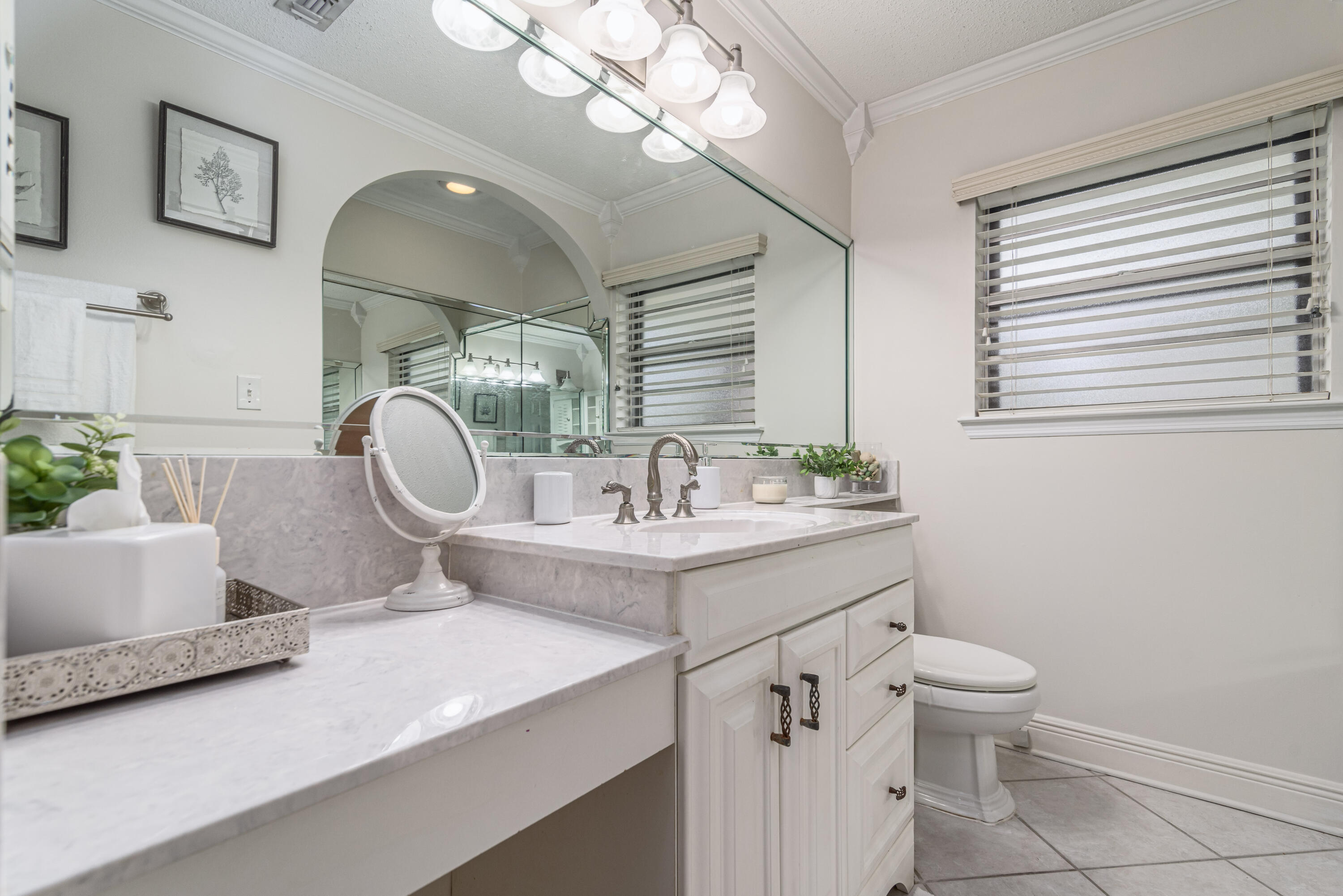 207 Country Club Road Shalimar, FL 32579 - Photo 49 of 60 a bathroom with a sink a toilet and a mirror