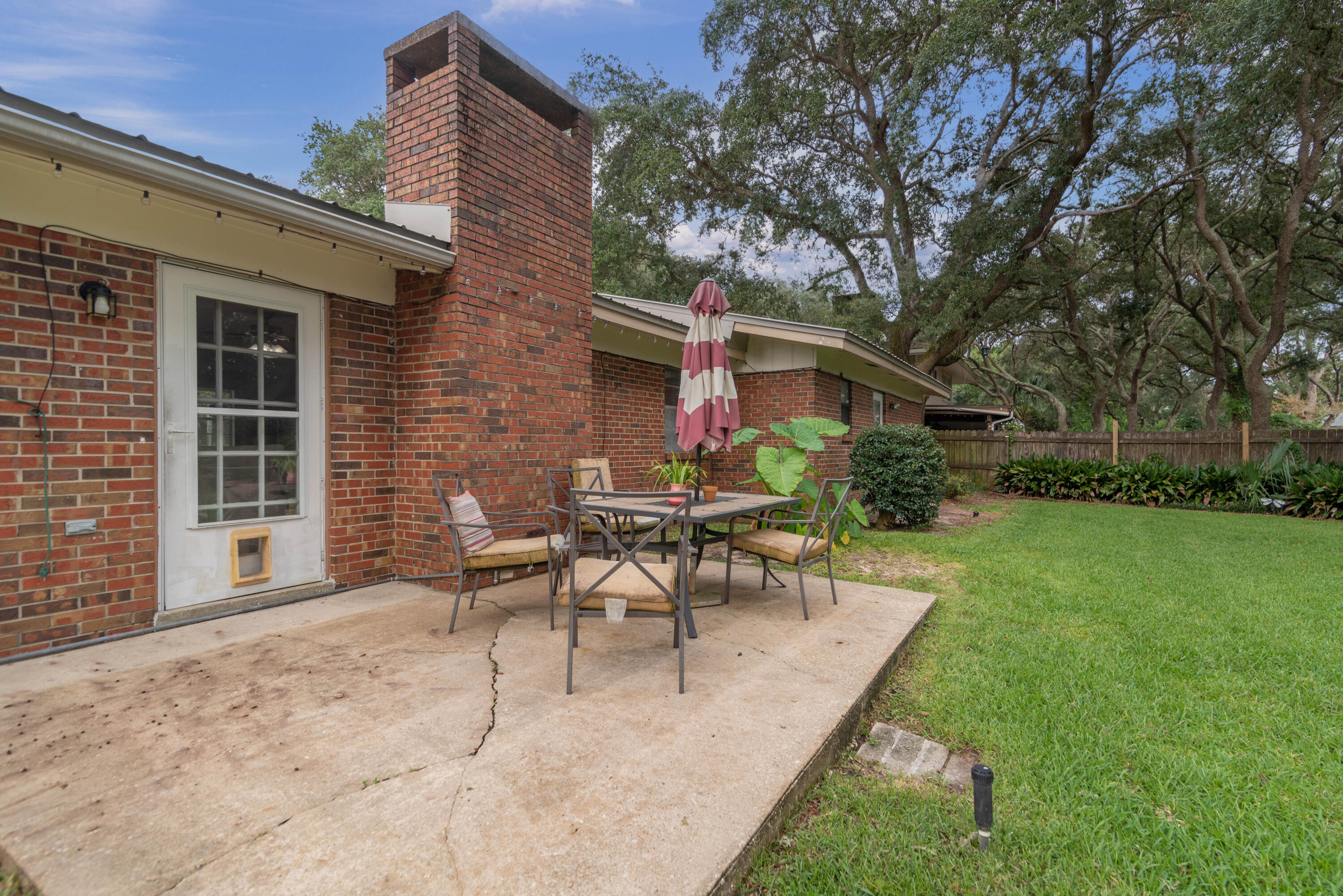 207 Country Club Road Shalimar, FL 32579 - Photo 55 of 60 a view of a house with backyard sitting area and garden