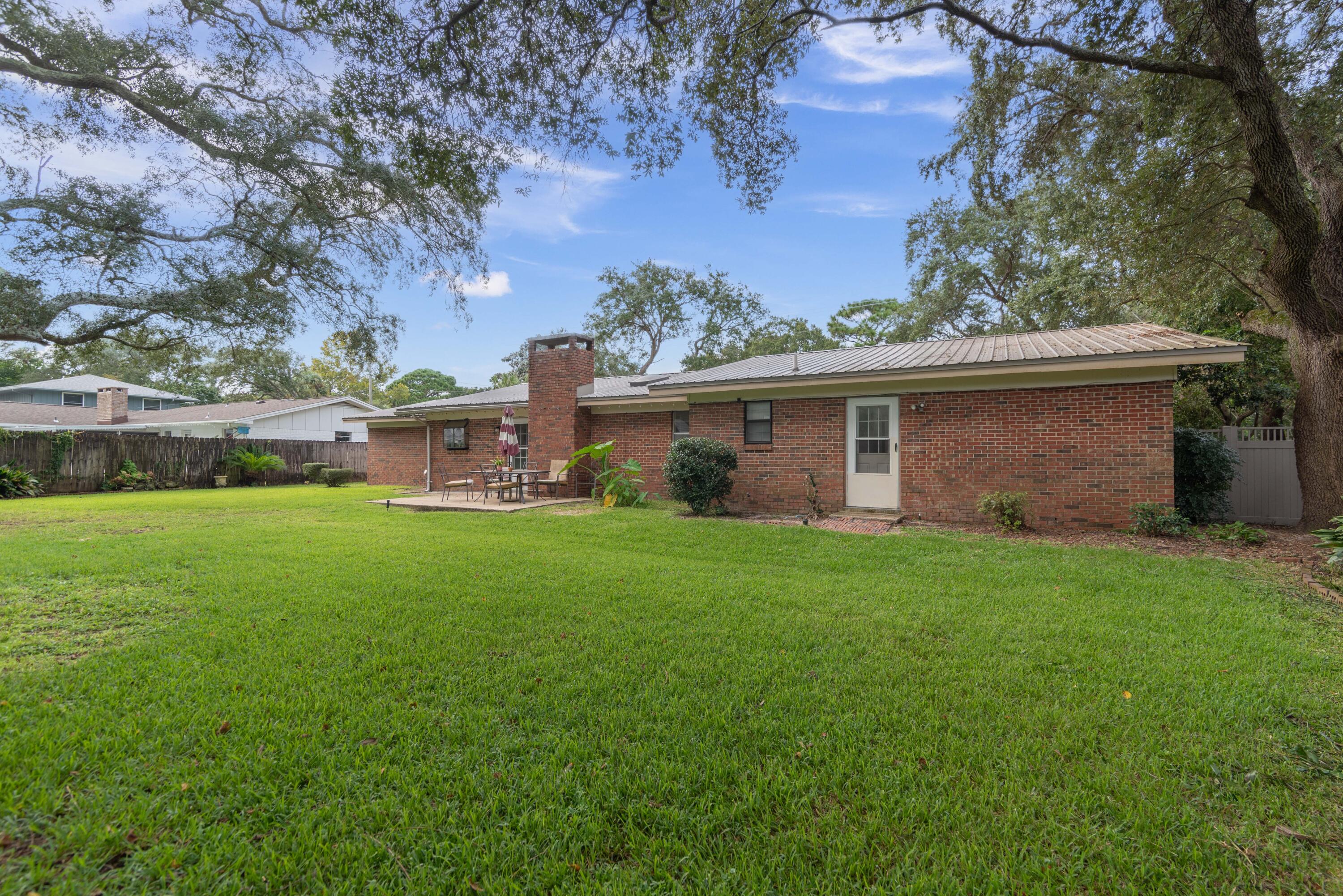 207 Country Club Road Shalimar, FL 32579 - Photo 58 of 60 a view of a house with backyard and garden