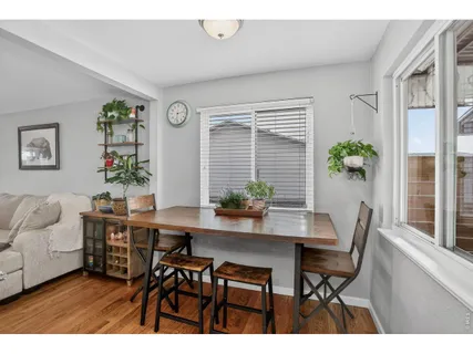 a view of a dining room with furniture and window