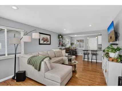 a living room with furniture potted plant and a flat screen tv
