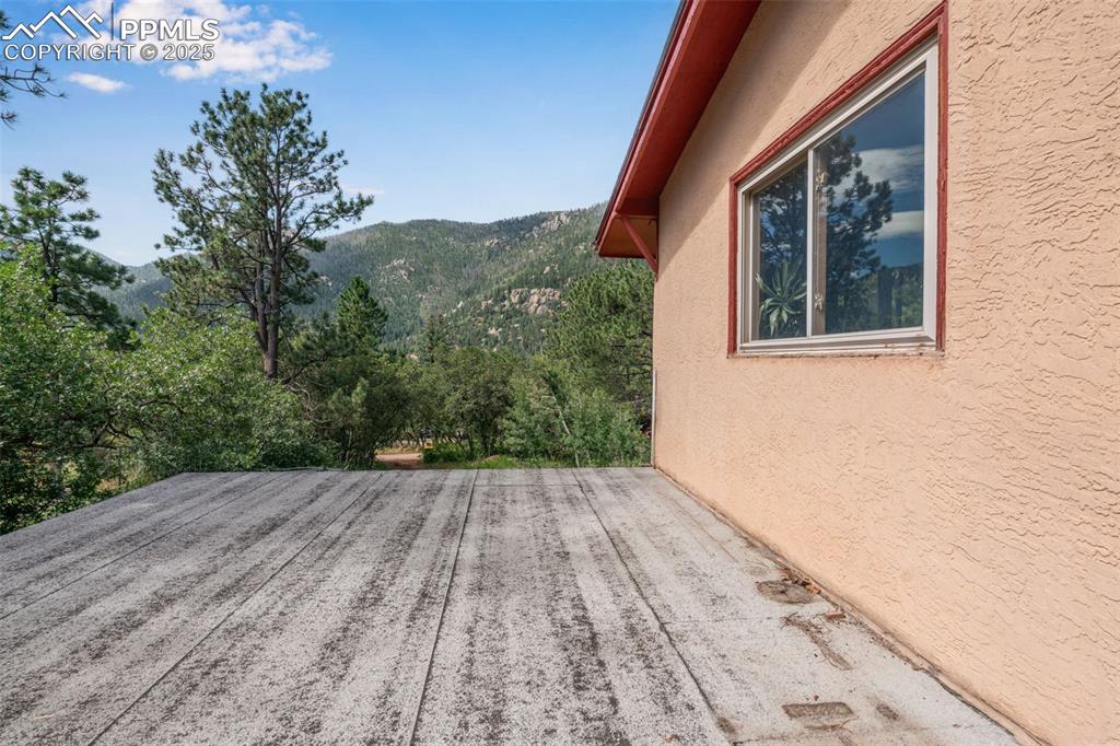 4415 Heizer Street Cascade, CO 80809 - Photo 34 of 50 Patio off of main level living room with a mountain view