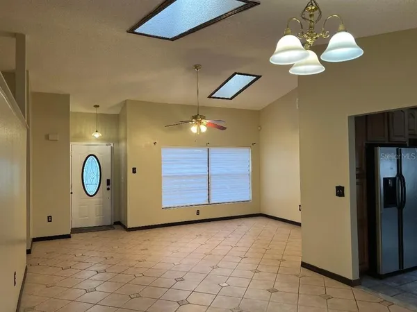 a view of a room with wooden floor and window