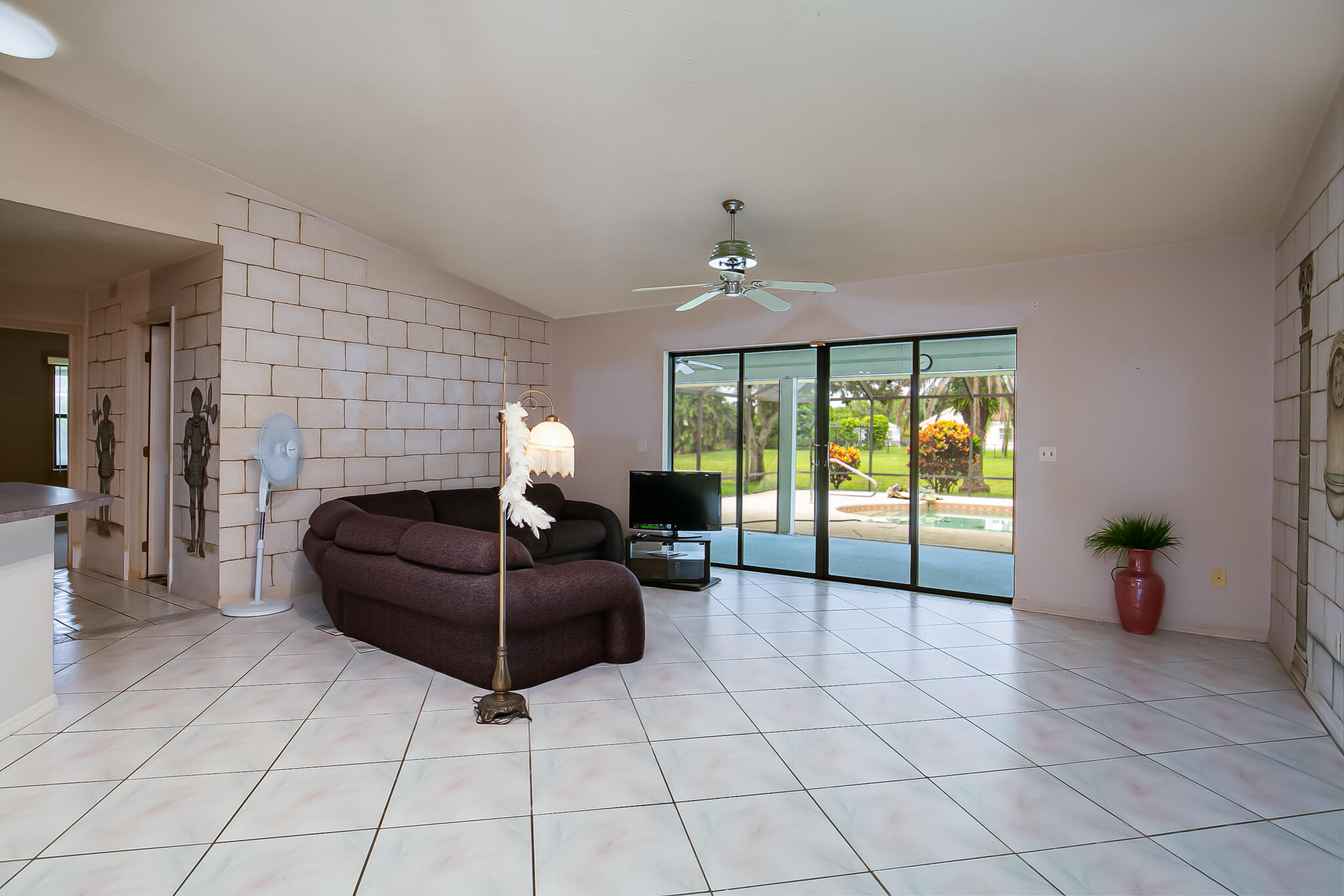 3013 Southeast Darien Road Port St. Lucie, FL 34952 - Photo 11 of 25 a living room with furniture a flat screen tv and a fireplace