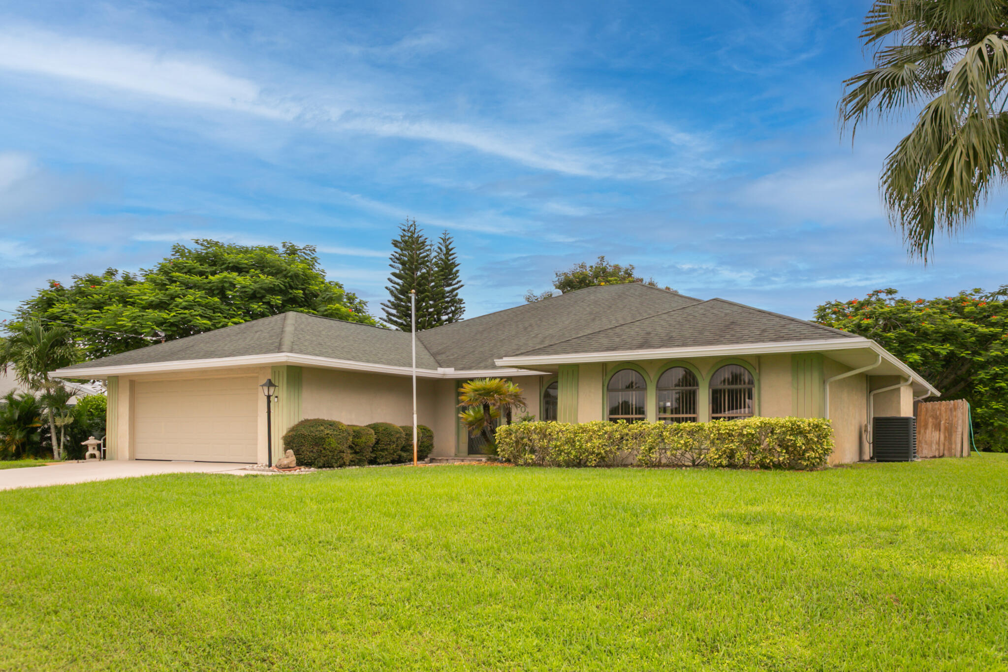 3013 Southeast Darien Road Port St. Lucie, FL 34952 - Photo 2 of 25 a front view of a house with a garden