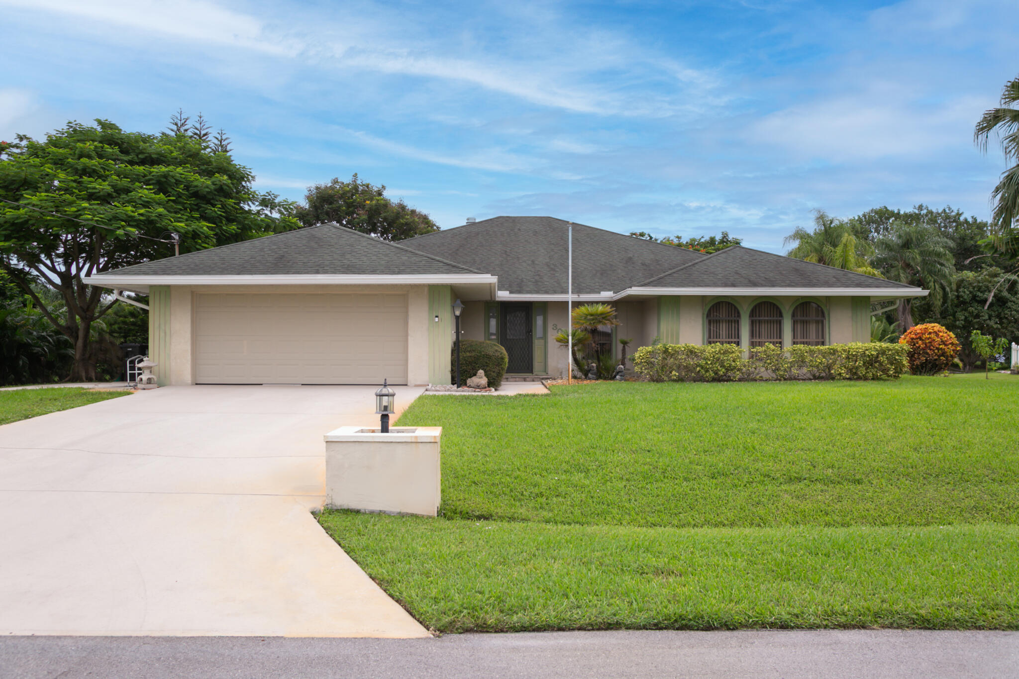 3013 Southeast Darien Road Port St. Lucie, FL 34952 - Photo 3 of 25 a front view of a house with a yard