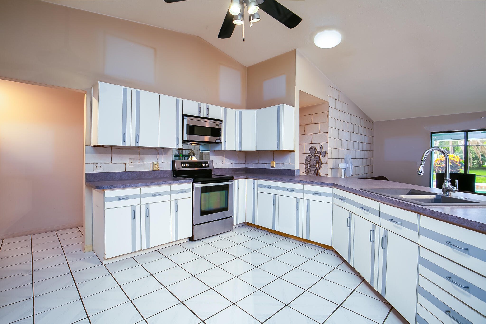 3013 Southeast Darien Road Port St. Lucie, FL 34952 - Photo 8 of 25 a kitchen with a sink cabinets and window