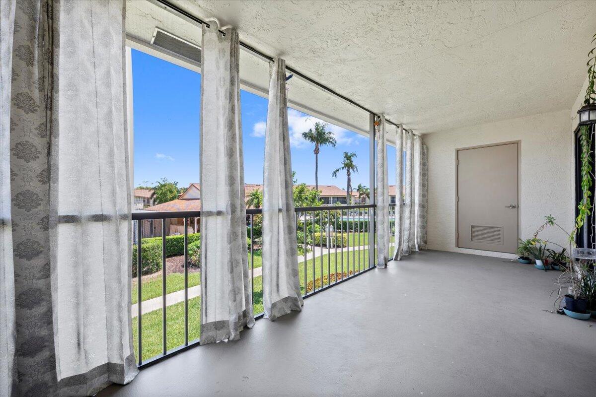 302 Pinecrest Circle, Unit D Jupiter, FL 33458 - Photo 16 of 23 Screened Balcony with storage