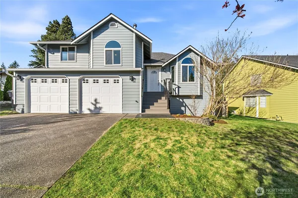 a front view of a house with a yard