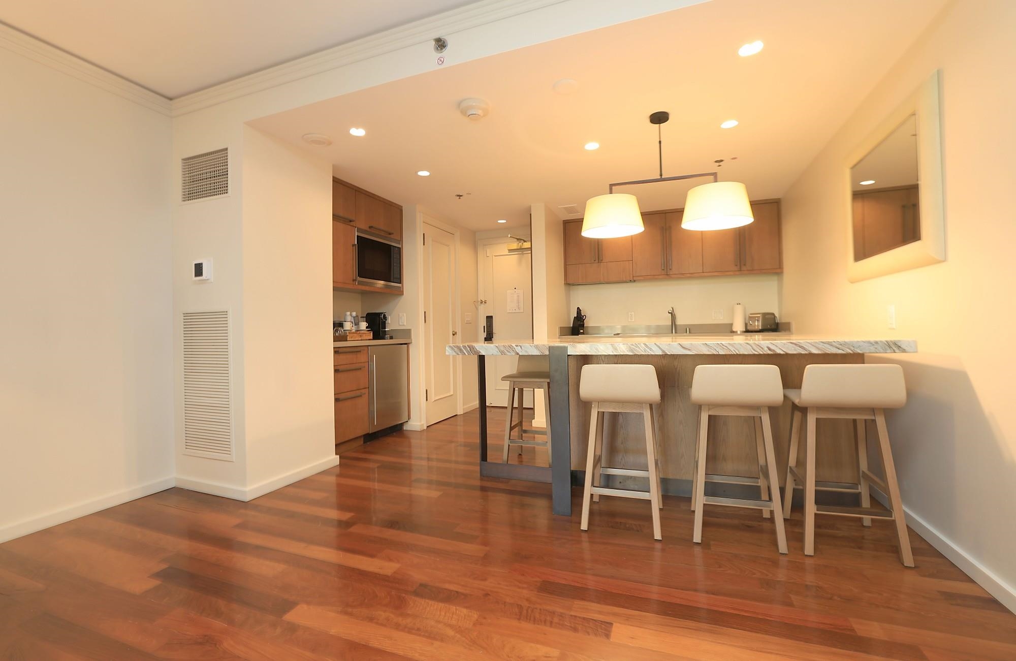 1 Ritz Carlton Drive, Unit 1502 Lahaina, HI 96761 - Photo 12 of 47 a kitchen with a table and chairs
