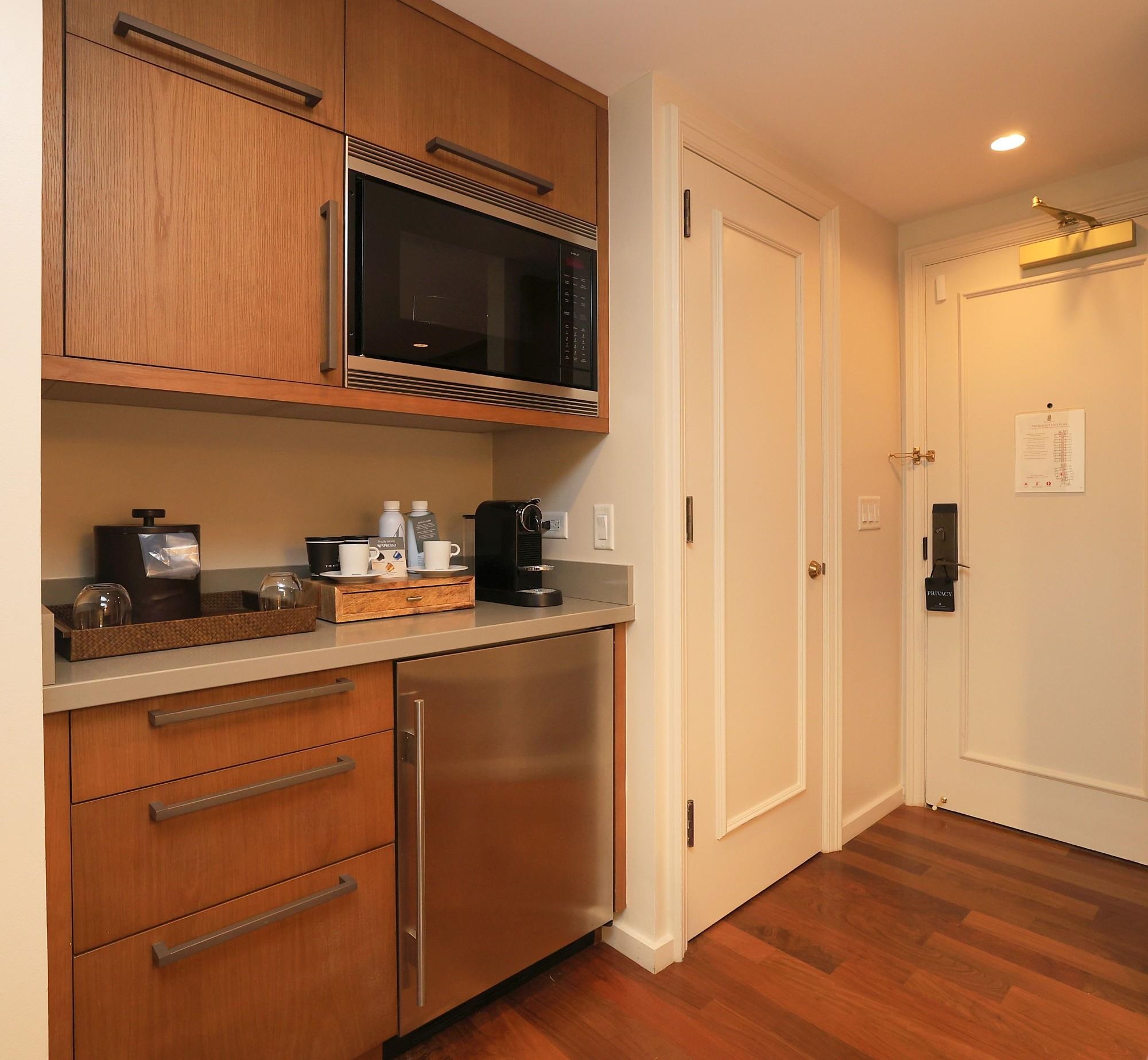 1 Ritz Carlton Drive, Unit 1502 Lahaina, HI 96761 - Photo 14 of 47 a kitchen with stainless steel appliances granite countertop a refrigerator a microwave oven with white cabinets and wooden floor