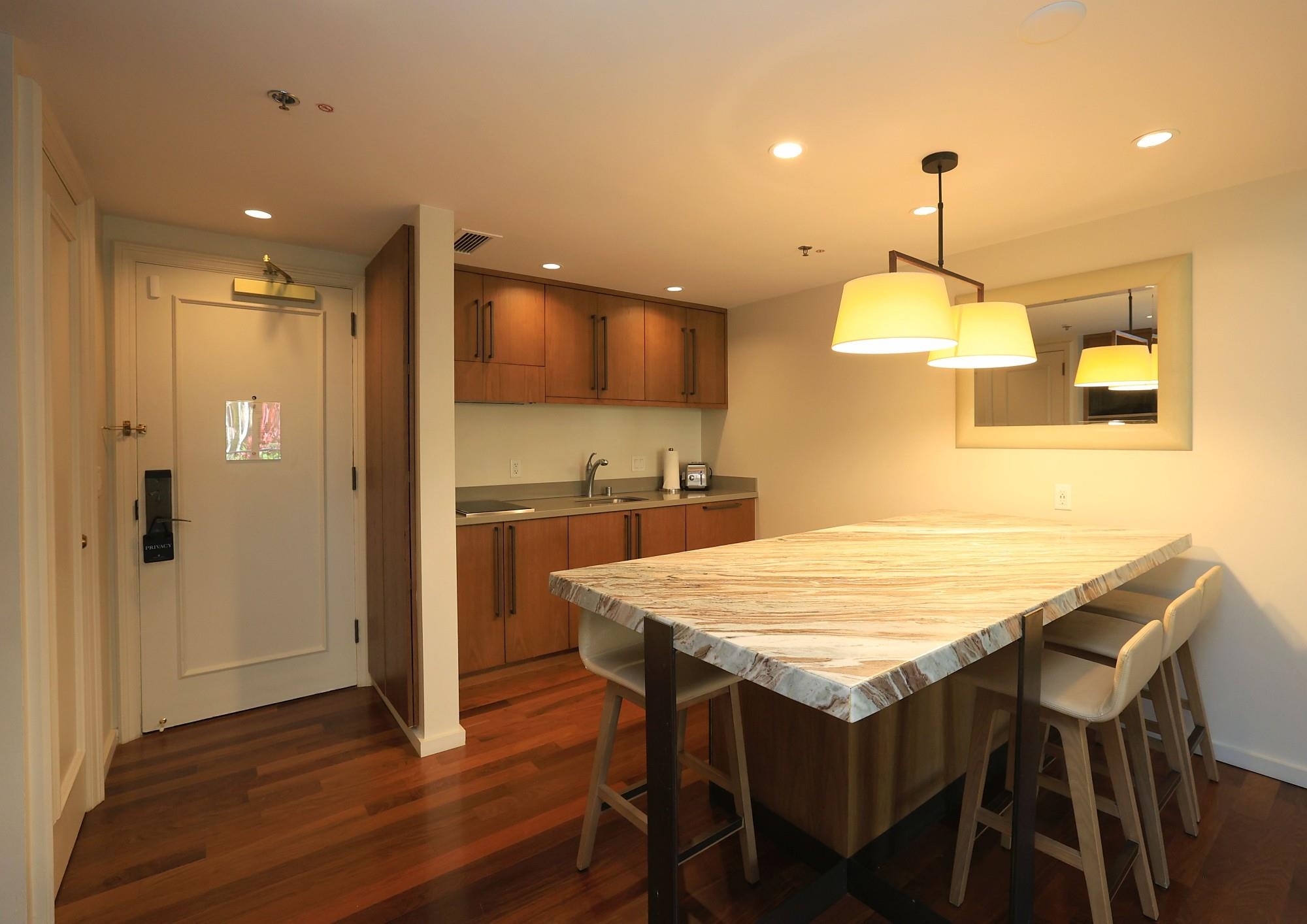 1 Ritz Carlton Drive, Unit 1502 Lahaina, HI 96761 - Photo 16 of 47 a kitchen with a table and chairs in it