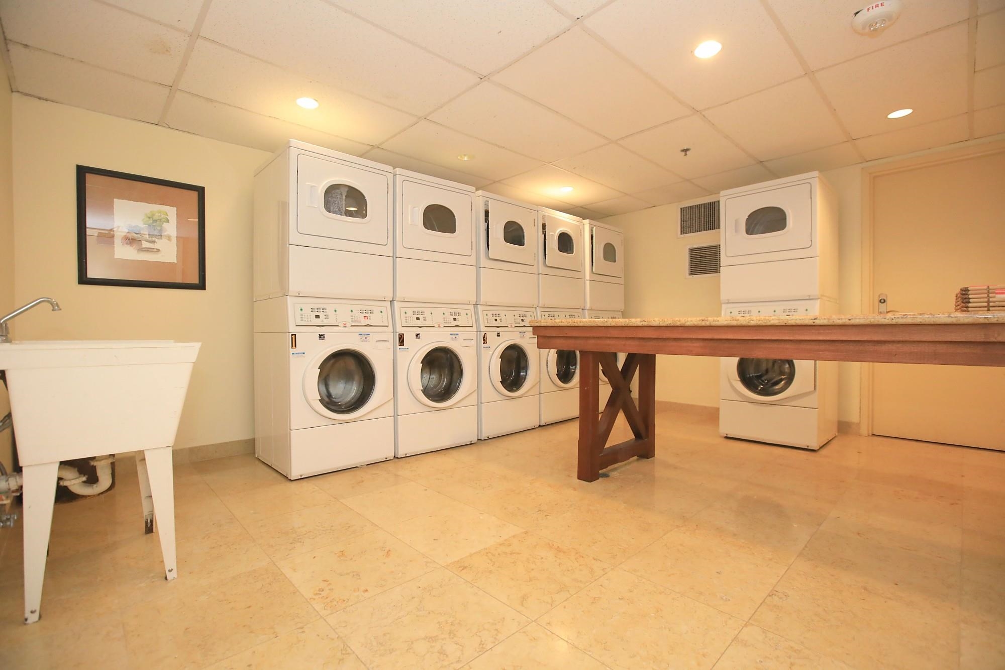 1 Ritz Carlton Drive, Unit 1502 Lahaina, HI 96761 - Photo 28 of 47 a utility room with a washing machine and a table chair
