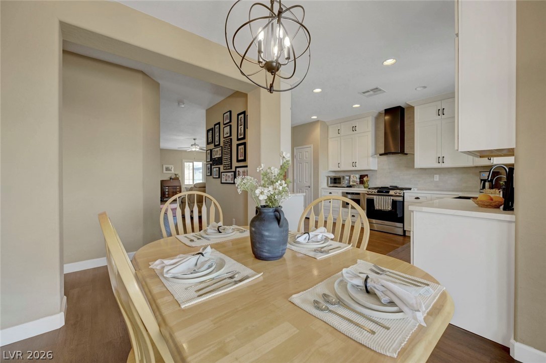 2700 Rue Montpellier Avenue Henderson, NV 89044 - Photo 13 of 39 Dining space featuring suspended lighting, dark wood-style floors, and a ceiling fan
