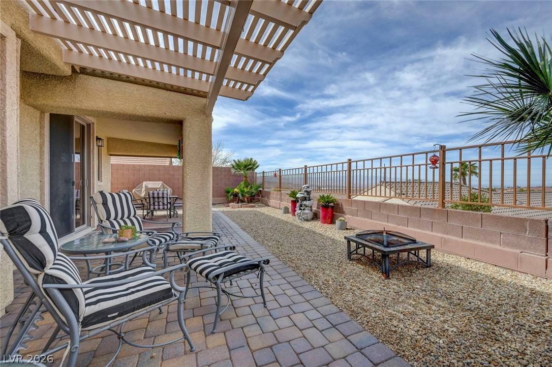 2700 Rue Montpellier Avenue Henderson, NV 89044 - Photo 35 of 39 Fenced backyard featuring a pergola, a patio, and a fire pit