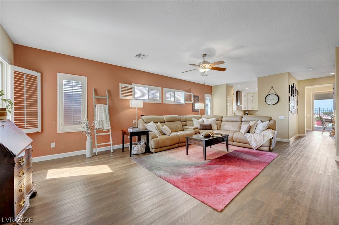 2700 Rue Montpellier Avenue Henderson, NV 89044 - Photo 8 of 39 Living room with a ceiling fan and light wood-style flooring