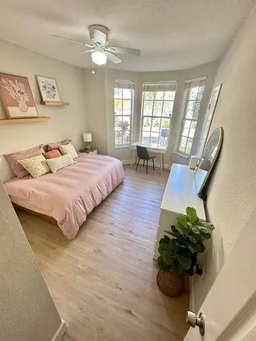a bedroom with a bed furniture and a chandelier