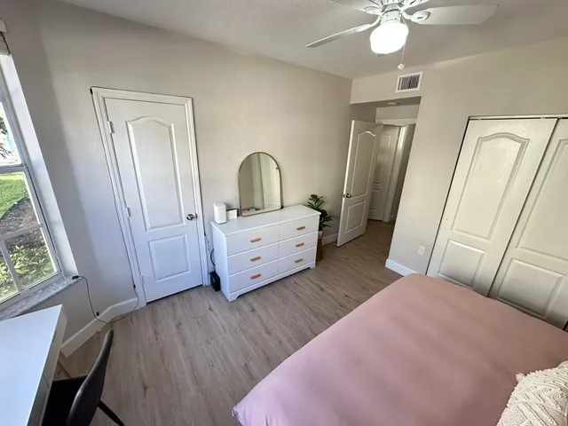 a bedroom with a bed and a mirror