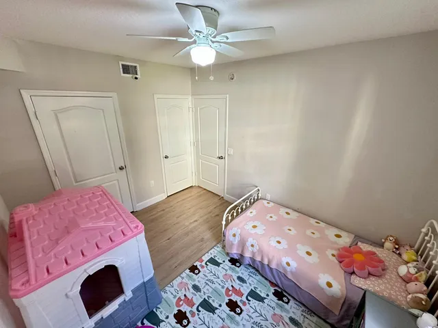 a bedroom with a bed and wooden floor