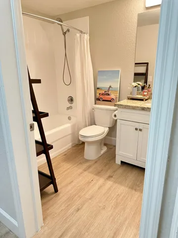 a bathroom with a shower toilet and a sink