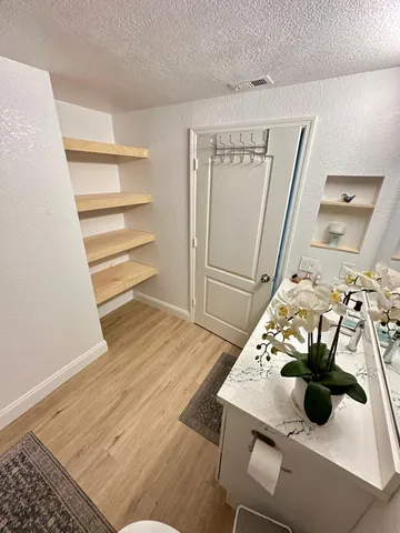 a view of a living room with furniture and wooden floor