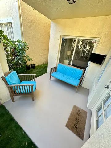 an outdoor space with furniture and garden