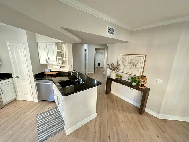 a kitchen view of a stove and wooden floor