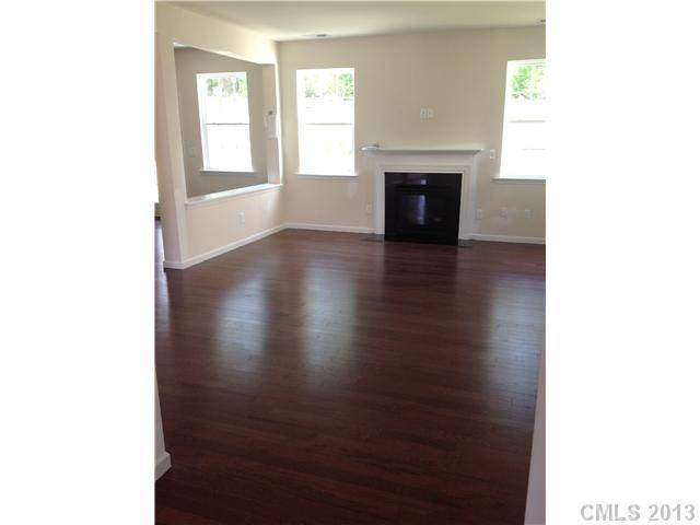 78054 Rillstone Drive Lancaster, SC 29720 - Photo 3 of 11 a view of a livingroom with wooden floor and a fireplace
