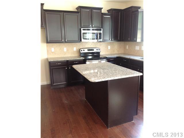 78054 Rillstone Drive Lancaster, SC 29720 - Photo 5 of 11 a kitchen with a sink cabinets and wooden floor