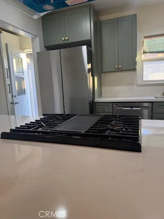 a kitchen with a stove and a refrigerator