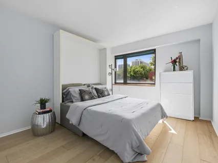 a bedroom with a bed and a window