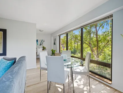 a view of a dining room with furniture large windows and wooden floor