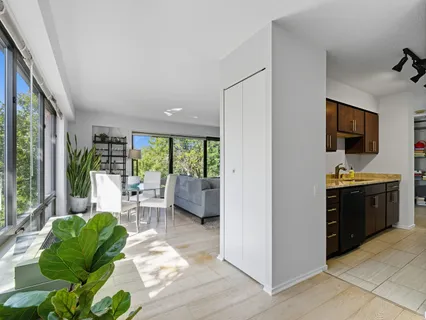 a living room with furniture large window and a flat screen tv
