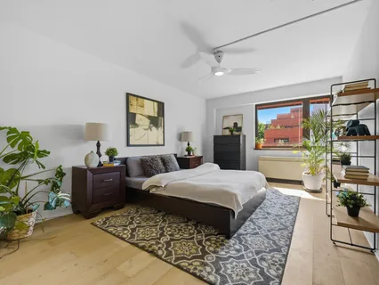 a bedroom with a large bed and a couch