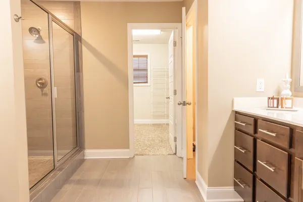 a bathroom with a shower and a sink