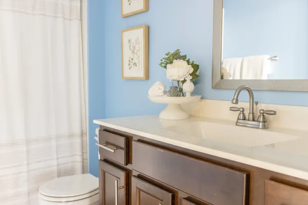 a bathroom with a sink a toilet and mirror
