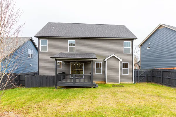 a front view of a house with yard and furniture