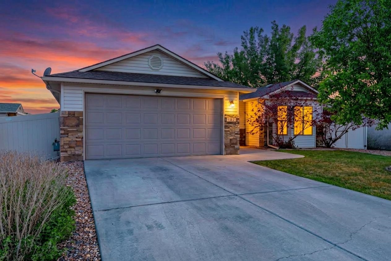 103 Red Rocks Street Fruita, CO 81521 - Photo 5 of 39 a front view of a house with a yard and garage