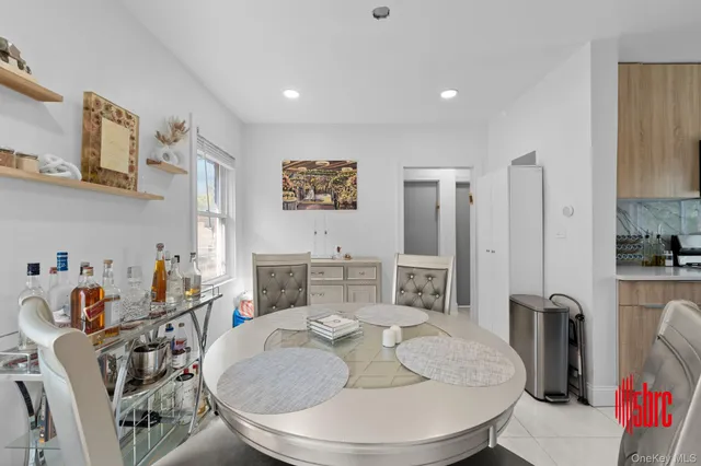 a living room with furniture and a dining table