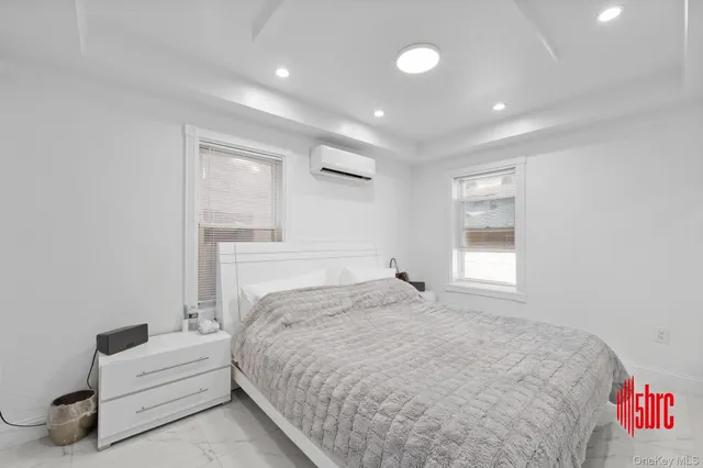 a spacious bedroom with a bed and a window