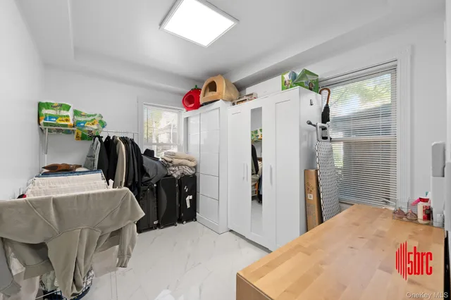 a room with a refrigerator and a wooden floor