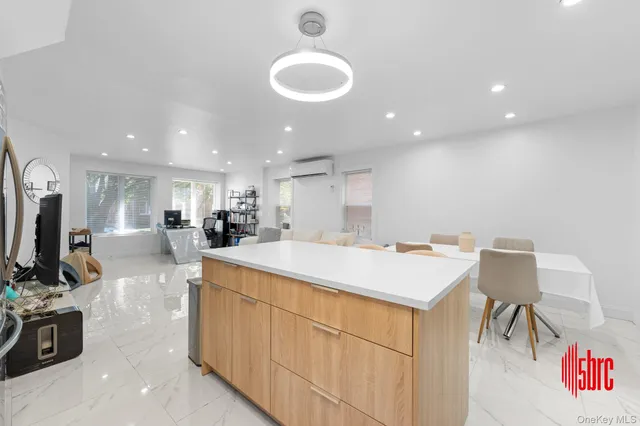 a kitchen with sink a microwave and cabinets